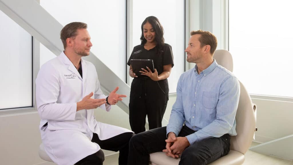 Dermatologist evaluating a patient with seborrheic dermatitis during a scalp consultation