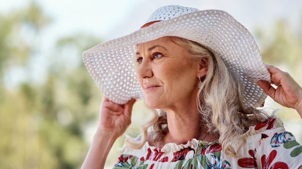 Woman wearing a wide-brim hat to protect skin during fluorouracil treatment