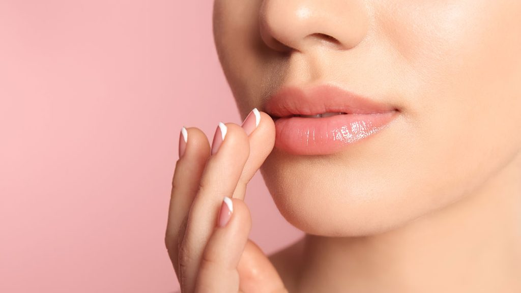 Woman with natural-looking full lips after lip filler treatment