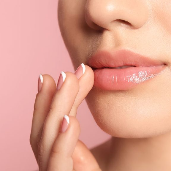 Woman with natural-looking full lips after lip filler treatment